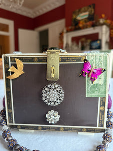 Elegant statement piece cigar box purse adorned with beautiful gems and jewelry