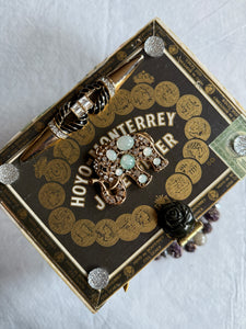 Elegant statement piece cigar box purse adorned with beautiful gems and jewelry